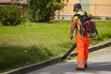 Man using electric leaf blowers