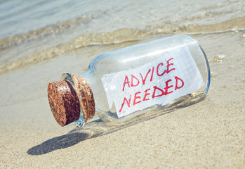 Message in a bottle "Advice needed". Creative help concept.