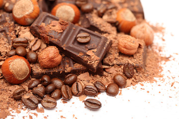 Pieces of chocolate with hazelnuts and coffee beans