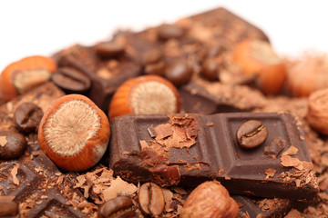 Pieces of chocolate with hazelnuts and coffee beans