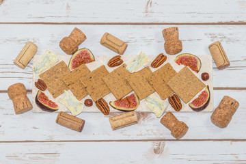 Fototapeta na wymiar Cheese and crackers with wine corks