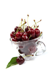 Fresh cherries in a glass dish.