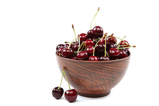 Fresh cherries in a wooden bowl.