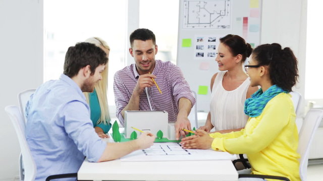 group of smiling architects working in office