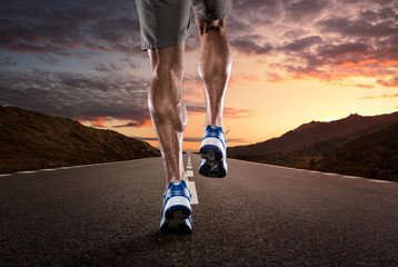 Close up of athlete running on the empty road
