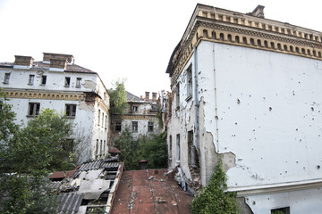 Fototapeta na wymiar Bullet-riddled rooms building exterior in Sarajevo