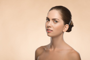 Young woman with beautiful healthy face - isolated on beige back