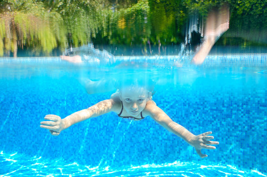 Kid swims in swimming pool, underwater and above view