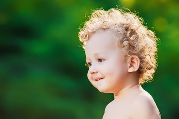 Cute little boy with blond curly hair