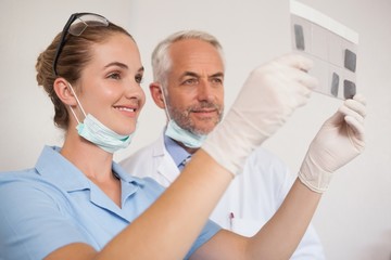 Fototapeta na wymiar Dentist and assistant studying x-rays