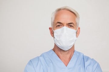 Dentist in surgical mask looking at camera