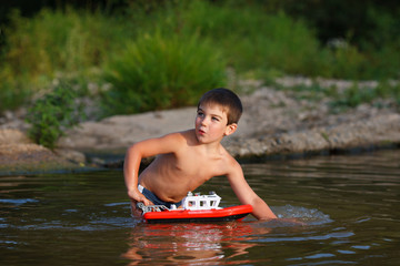 Fototapeta premium Boy playing in the river