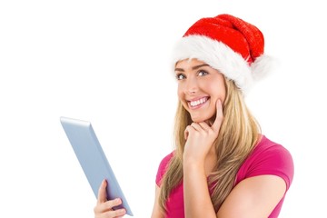 Festive blonde using tablet pc