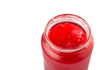 A bottle of strawberry jam over white background 