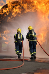 Naklejka premium fire fighters at large fire