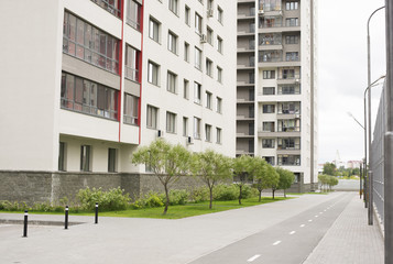 Modern building with road, grass and trees