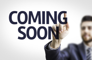 Business man pointing the text: Coming Soon