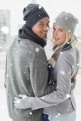 Cute couple in warm clothing hugging smiling