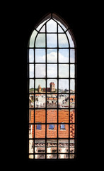 Distorted view of Torun old town seen through church stained glass widnow, Poland