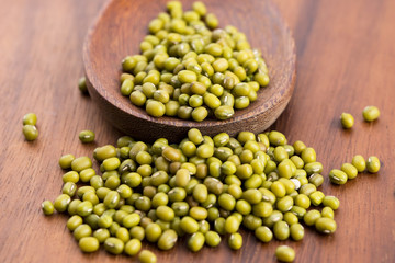 Mung beans over wooden spoon