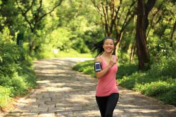 young fitness woman runner running on country road