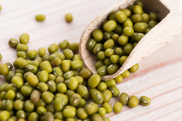 Mung beans over wooden spoon