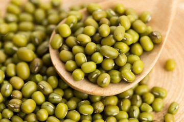 Mung beans over wooden spoon