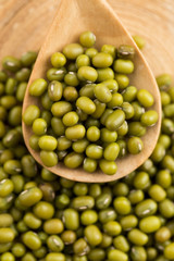 Mung beans over wooden spoon