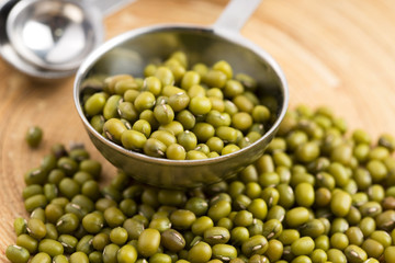 Mung beans over wooden spoon