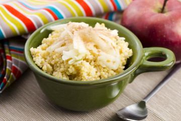 Portion of sweet millet porridge with apple and cinnamon