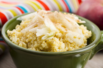 Portion of sweet millet porridge with apple and cinnamon