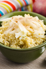 Portion of sweet millet porridge with apple and cinnamon