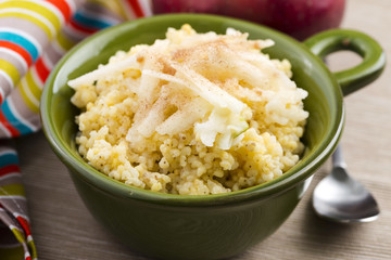 Portion of sweet millet porridge with apple and cinnamon
