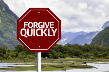 Forgive Quickly red sign with a landscape background