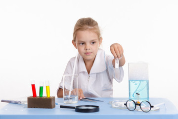 Trainee holds a vial with white powder