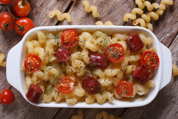 pasta baked with cherry tomatoes and sausages top view