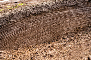 Mountain Bike Tracks in Mud Background
