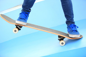 Fototapeta na wymiar woman skateboarder legs on skatepark 