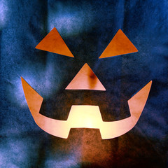 Glowing Jack o Lantern Face Cut from Paper Bag