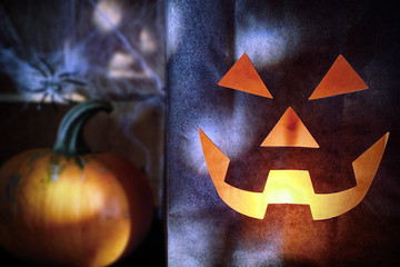 Paper Bag Jack o Lantern with Pumpkin in Distance
