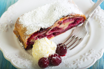 Plate with cherry strudel closeup.