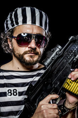 Security.Prison riot concept. Man holding a machine gun, prisone