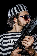 Security.Prison riot concept. Man holding a machine gun, prisone