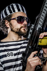 Security.Prison riot concept. Man holding a machine gun, prisone