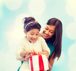 happy mother and child girl with gift box