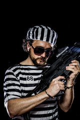 Weapon .Prison riot concept. Man holding a machine gun, prisoner
