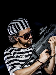 Opposition .Prison riot concept. Man holding a machine gun, pris