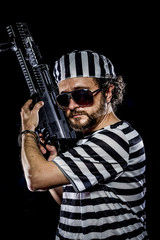 protest .Prison riot concept. Man holding a machine gun, prisone