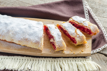 Cherry strudel on the wooden board