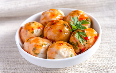 Chicken meatballs with parmesan under spicy sauce